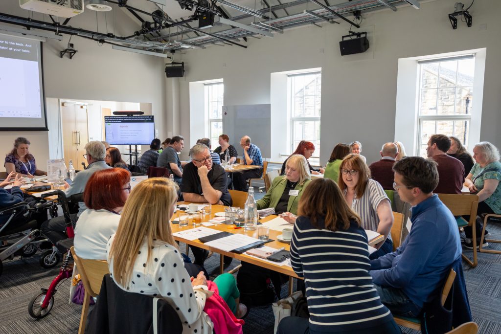 People taking part in a group discussion at a community workshop